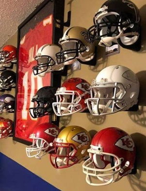 Display of full-size football helmets with jersey